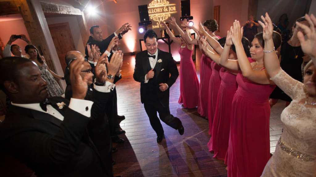 spot-light-following-groom-as-he-dances-down-the-line