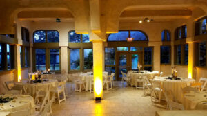 yellow-uplights-on-stone-spanish-style-venue-indoor-reception-area