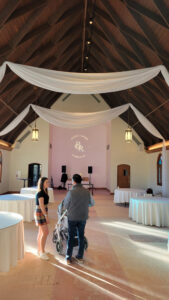 white-pipe-and-drape-across-venue-with-pink-accent-wall