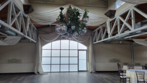 discor-balls-in-front-of-window-with-white-drape-and-greenery