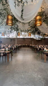 greenery-with-dining-hall-and-white-drape-and-string-lights