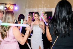happy-bride-dancing-with-dance-floor-lights-gleaming-in-background
