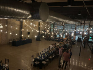 modern-venue-with-steel-and-wood-with-string-lights-giving-a-moody-glow-for-reception