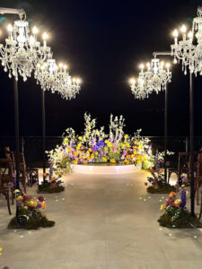 beautiful-walkway-with-floral-backdrop-and-beaded-chandeliers