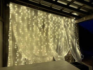 fairy-light-curtain-with-white-drape