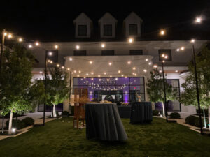 modern-corporate-event-set-up-with-outdoor-from-home-and-string-lights