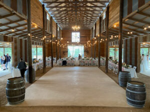 wood-venue-with-wine-barrel-tables-indoor-and-white-tables